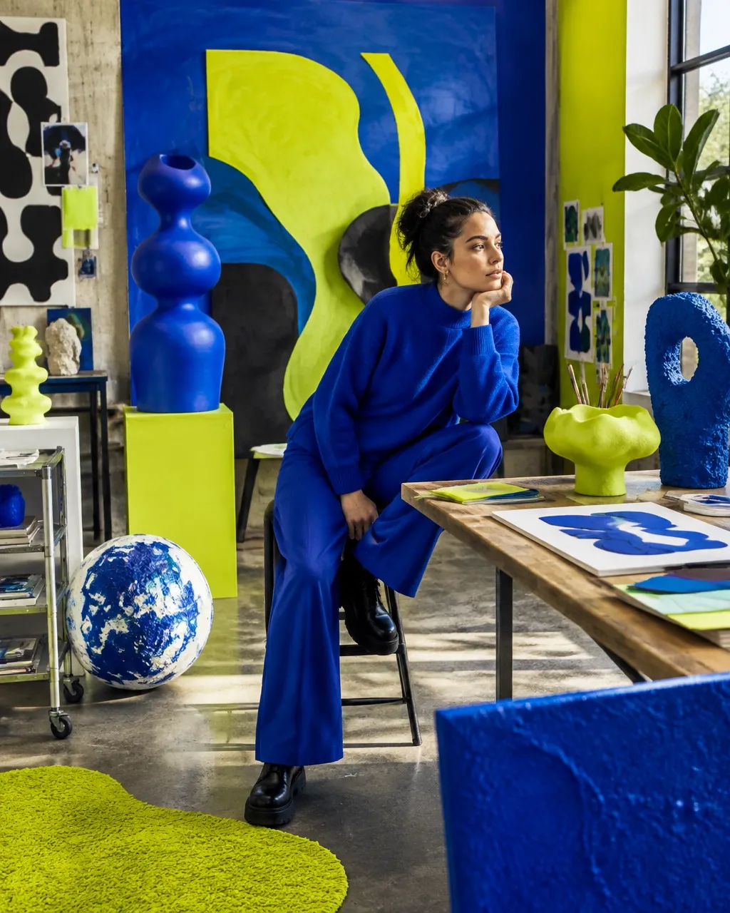 Vivid creative studio with cobalt blue and electric chartreuse art and sculptural pieces